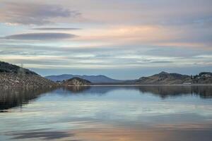 calm winter dusk over mountain lake photo