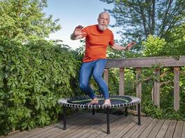 senior man on mini trampoline photo