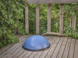 Balance training ball on wooden deck photo