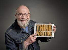 senior man with think positive sign photo