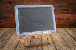 blank blackboard sign on rustic wood photo