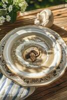 Mushroom cream soup served on a table in the garden photo