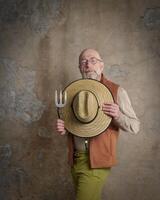 senior, bearded man with a straw sun hat photo