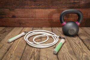 heavy fitness jump rope and iron kettlebell photo