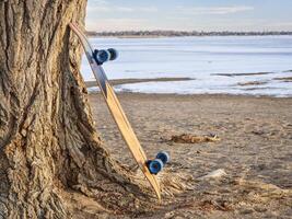 cruising longboard on a lake shore photo