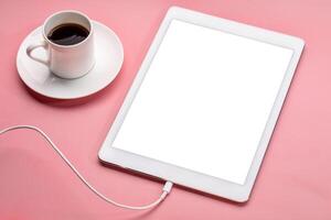 digital tablet with blank screen on a pink background photo