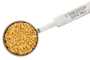 golden flax seed on measuring spoon photo