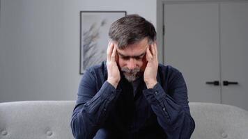 Sad hopeless senior man sit alone at home feeling desperate depressed, upset stressed male suffer from alcohol abuse drug addiction, dependency, grief or guilt troubled with problems video