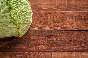 savoy cabbage on rustic wood photo
