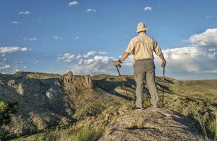 hiker with trekking poles photo