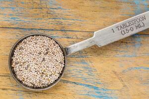 white chia seeds on a tablespoon photo