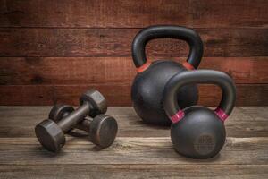 iron kettlebells and a pair of dumbbells photo