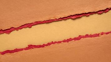 paper abstract in orange and red with a copy space - sheets of handmade paper, diagonal blank web banner, warning, alert and danger concept photo
