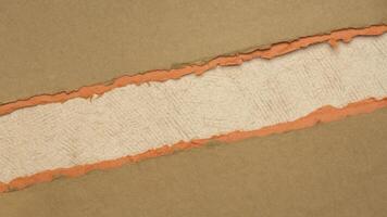 paper abstract in orange and pumpkin tones with a copy space - sheets of handmade paper, blank web banner photo