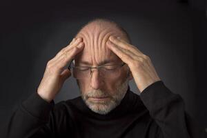 tired elder man with glasses photo