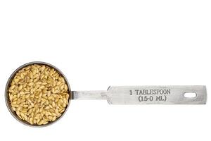 golden flax seeds in a tablespoon in a tablespoon photo