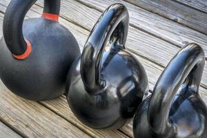 heavy iron kettlebels on a deck photo