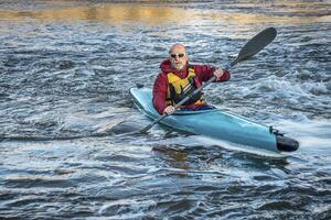 senior male paddler kayaking photo