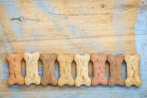 row of milk bones on wood photo