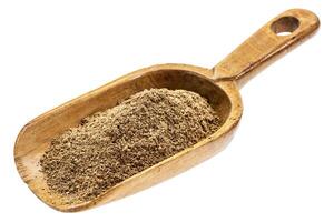 rustic scoop of noni fruit powder photo