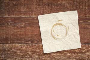 napkin with coffee stains on wood photo