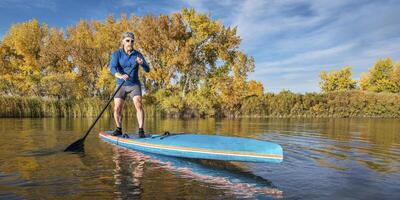 stand up paddling in fall colors photo