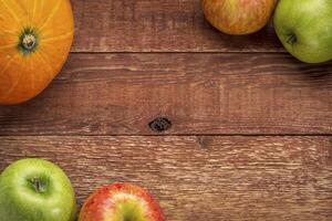 rustic barn wood with pumpkin and apples photo