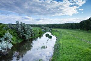 Beautiful summer landscape with green trees, green meadows on the bank of the river in Republic of Moldova. photo