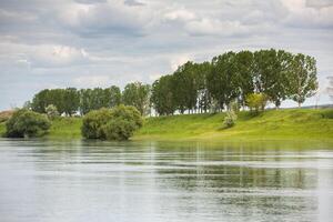 Beautiful summer landscape with green trees, green meadows on the bank of the river in Republic of Moldova. photo