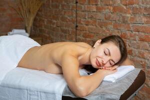 Portrait of a young woman in a spa salon. Beauty treatment. photo