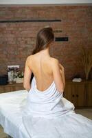 Portrait of a young woman in a spa salon. Beauty treatment. photo