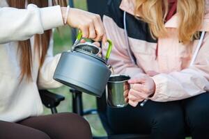 Portrait of a beautiful young woman with cup of tea outdoors. photo
