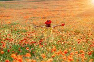 Happy girl poppy field walks under the evening sun. Back view photo