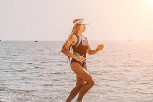 Woman travel summer sea. A happy tourist in a blue bikini enjoying the scenic view of the sea and volcanic mountains while taking pictures to capture the memories of her travel adventure. photo