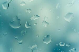 Water drops on glass against blue sky. Window view background screensaver. Place for text banner. photo