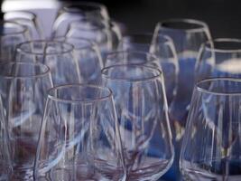 many clean wine glasses on restaurant table photo