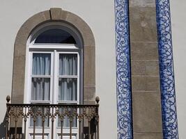 blue ceramic tiles on Old town building in Aveiro pictoresque village street view, The Venice Of Portugal photo