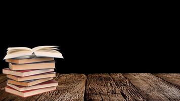 World book day. Stack of colorful books with open book on teal background. Education photo