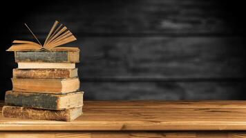 World book day. Stack of colorful books with open book on teal background. Education photo