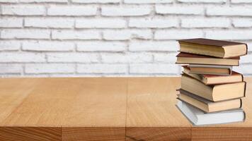 World book day. Stack of colorful books with open book on teal background. Education photo