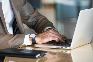 Diligent businessman engrossed in work at his laptop during a busy office hour photo