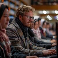 Group of Diverse Individuals Focused on Their Computers in a Library Setting photo