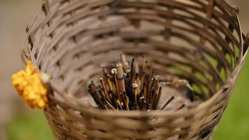 rained incense sticks at the bottom of a wicker basket, an altar for offerings video