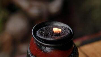 the flame of a lamp against the background of a blurred nature, oil ritual lamp video