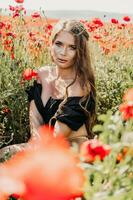 Woman poppies field. portrait happy woman with long hair in a poppy field and enjoying the beauty of nature in a warm summer day. photo