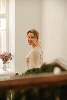 a woman in a flower dress descends the stairs photo