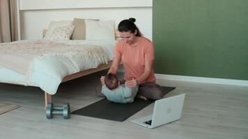 casa isolamento, ginástica às lar, família quarentena, Esportes criança, esporte família. mãe e bebê Faz fisica exercícios às casa perto a cama video