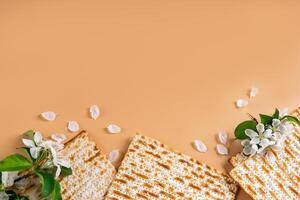 Spring flowers and matzo bread on beige background. photo
