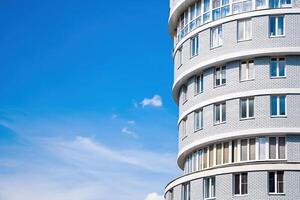 Modern multi-storey building against the blue sky. photo