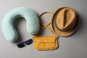 Packed suitcase of vacation items on grey background, top view photo